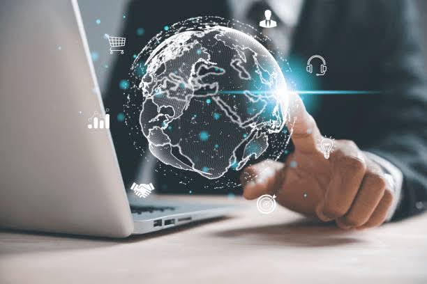Digital globe projected above a laptop, connecting global markets